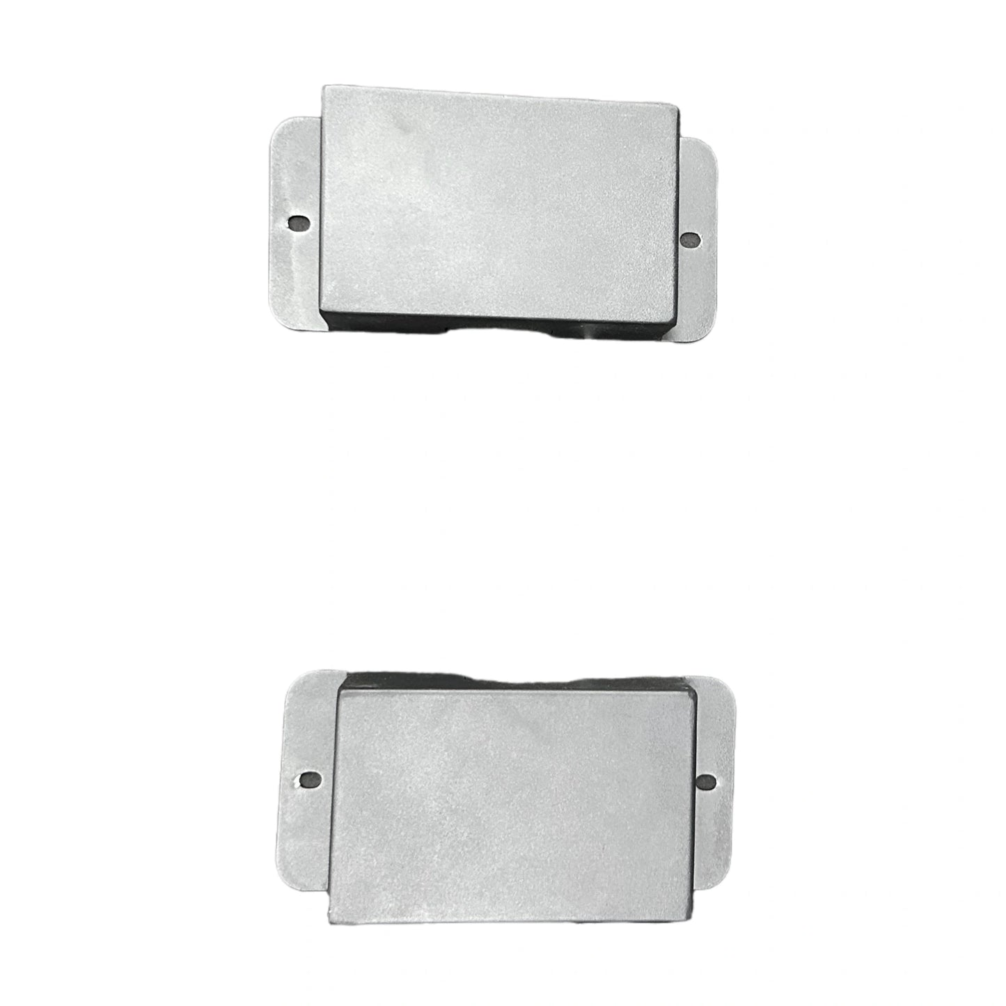 Two rectangular metal filters on a white background
